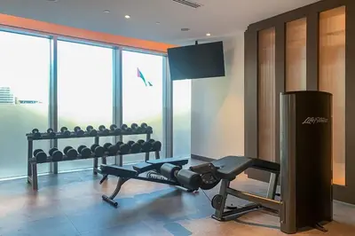 a room with a gym with a treadmill and a television at Frank Porter - Opera Grand in Dubai