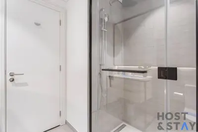 a bathroom with a shower and a glass door at Boutique Studio in Wilton Park MBR City in Dubai