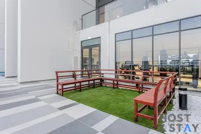 a balcony with benches and grass in a building at Boutique Studio in Wilton Park MBR City in Dubai