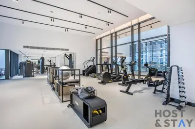 a gym with lots of treadmills and machines at Boutique Studio in Wilton Park MBR City in Dubai