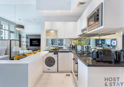 a kitchen with a washer and dryer on a counter at Upgraded Studio in Business Bay in Dubai