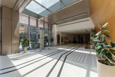an empty lobby with plants in a building at Elegant studio in Sparkle Tower by Suiteable in Dubai