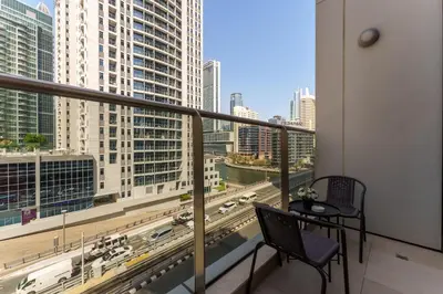 a balcony with a table and a view of a city at Your gateway in Sparkle Tower JBR by Suiteable in Dubai