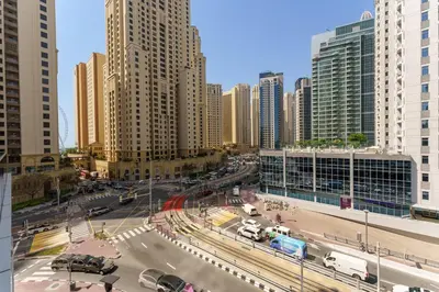 a city with tall buildings and a street with cars at Your gateway in Sparkle Tower JBR by Suiteable in Dubai