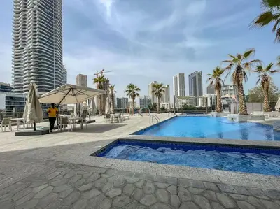 a swimming pool with a city skyline in the background at Your gateway in Sparkle Tower JBR by Suiteable in Dubai