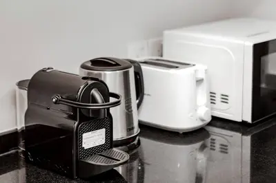 a counter top with a coffee maker and toaster at DAMAC APARTMENTS in Dubai
