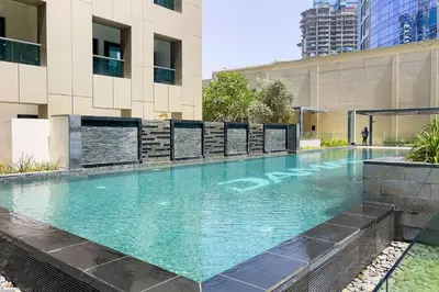 a swimming pool in front of a building at DAMAC APARTMENTS in Dubai