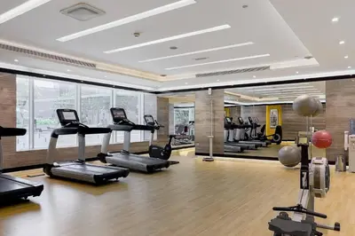 a gym with treadmills and ellipticals in a room at DAMAC APARTMENTS in Dubai
