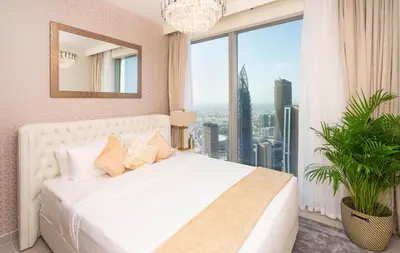 a bedroom with a white bed and a large window at Elite Royal Apartment - Panoramic with Burj Khalifa & Full Fountain View - High Floor - Patron in Dubai
