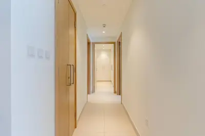 a hallway with white walls and a long corridor at Stylish and Cozy l Park View l Next to Mall in Dubai