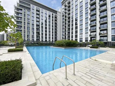 a large swimming pool in front of two tall buildings at Stylish and Cozy l Park View l Next to Mall in Dubai
