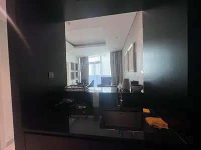 a bathroom with black walls and a large mirror at Damac Maison Distinction in Dubai