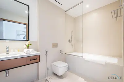 a bathroom with a toilet and a sink and a shower at Chic 1BR in VIDA Residences Dubai Marina by Deluxe Holiday Homes in Dubai