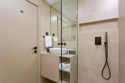 a bathroom with a sink and a shower at Marina Seaside Living prime location by the beach in Dubai