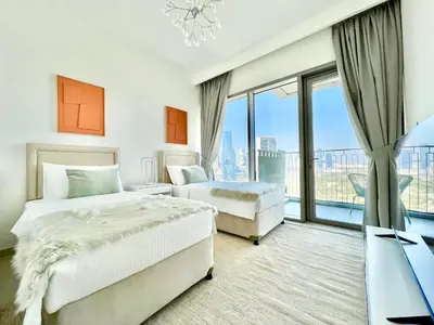 a bedroom with two beds and a large window at Downtown Views 2BR - Dubai Mall, Fountain & Burj Khalifa access in Dubai