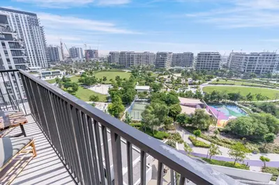 a balcony with a view of a park at Branded 2BR Residence with Direct Park Access in Dubai