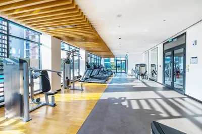 a gym with treadmills and cardio equipment in a building at Branded 2BR Residence with Direct Park Access in Dubai