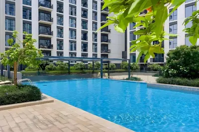 a swimming pool in front of a building at Branded 2BR Residence with Direct Park Access in Dubai