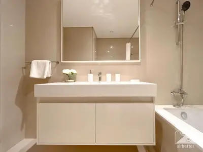 a bathroom with a white sink and a mirror at Luxurious Living in 2B with Burj & Fountain Views in Dubai