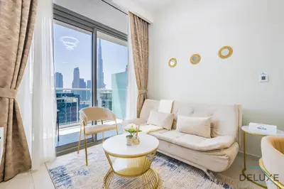 a living room with a couch and a large window at Charming 1BR Apartment in Vera Tower, Business Bay by Deluxe Holiday Homes in Dubai