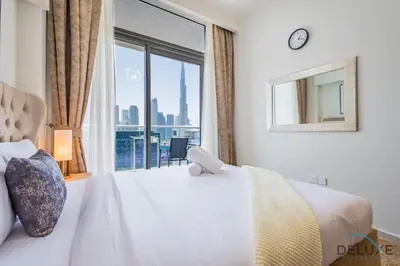 a bedroom with a bed and a large window at Charming 1BR Apartment in Vera Tower, Business Bay by Deluxe Holiday Homes in Dubai