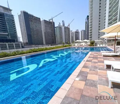a swimming pool on the roof of a building with tall buildings at Charming 1BR Apartment in Vera Tower, Business Bay by Deluxe Holiday Homes in Dubai