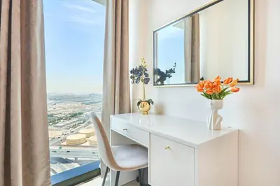 a white desk with a chair and a window at Beachfront 1BR Retreat at Address JBR in Dubai
