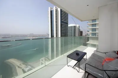 a balcony with a view of a city at Incredible Sea view 2BHK - Private beach Access - Emaar Beachfront in Dubai
