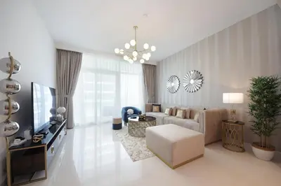 a living room with a couch and a tv at Incredible Sea view 2BHK - Private beach Access - Emaar Beachfront in Dubai