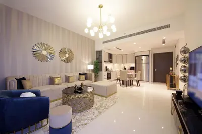 a large living room with a couch and a table at Incredible Sea view 2BHK - Private beach Access - Emaar Beachfront in Dubai
