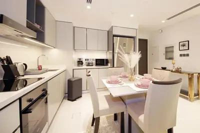 a kitchen and dining room with a table and chairs at Incredible Sea view 2BHK - Private beach Access - Emaar Beachfront in Dubai