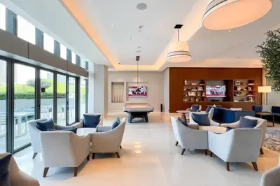 a waiting room with chairs and a pool table at GuestReady - Downtown Dubai luxurious stay in Dubai