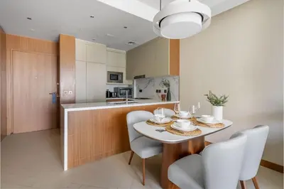 a kitchen and dining room with a table and chairs at GuestReady - Downtown Dubai luxurious stay in Dubai