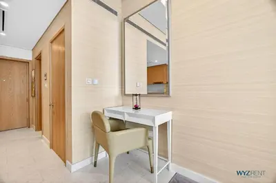 a room with a table and a chair and a mirror at Breathtaking 1BR in Palm Tower, with Sea View in Dubai