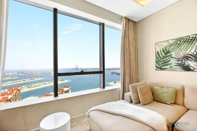 a living room with a couch and a large window at Breathtaking 1BR in Palm Tower, with Sea View in Dubai