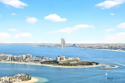 an aerial view of a city and the ocean at Breathtaking 1BR in Palm Tower, with Sea View in Dubai
