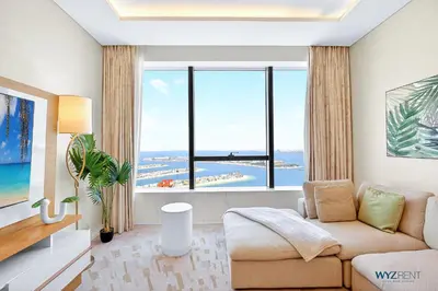 a living room with a couch and a large window at Breathtaking 1BR in Palm Tower, with Sea View in Dubai