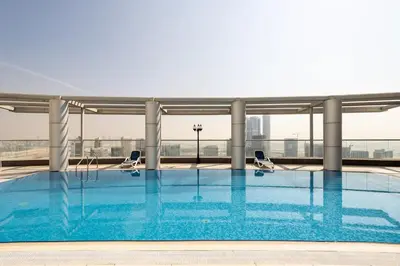 a swimming pool on the roof of a building at Dubai Downtown Dubai Mall & Burj Khalifa DIFC 5 mins in Dubai