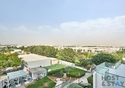 an aerial view of a city with buildings at Serene 1 BR in Damac Hills - Host & Stay in Dubai