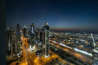 a view of a city at night with lights at Panoramic Sea View 2BR in Forte Downtown - Allsopp&Allsopp in Dubai