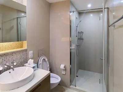 a bathroom with a shower and a sink and a toilet at Claren Tower 2 - Downtown by Golden Casa in Dubai