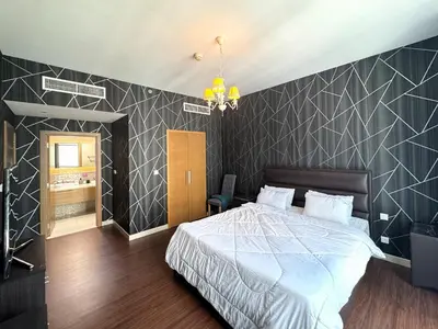 a bedroom with a bed and a black and white wall at Claren Tower 2 - Downtown by Golden Casa in Dubai