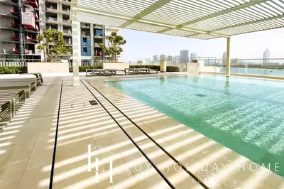 a swimming pool on the roof of a building at LUX The Marina Vista Beachfront Suite 2 in Dubai