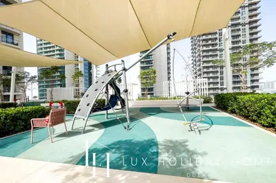 a playground with a slide and two chairs at LUX The Marina Vista Beachfront Suite 2 in Dubai