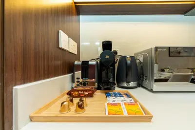 a coffeemaker on a counter with a coffee maker at GLOBALSTAY Creek Edge Tower Elegant Apartments in Dubai