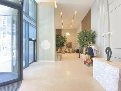 an office lobby with a hallway with potted plants at GLOBALSTAY Creek Edge Tower Elegant Apartments in Dubai