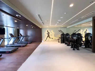 a gym with treadmills and exercise equipment in a room at GLOBALSTAY Creek Edge Tower Elegant Apartments in Dubai
