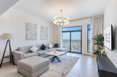 a living room with a couch and a table at One Bedroom Apartment in Madinat Jumeirah Living by The S Holiday Homes in Dubai