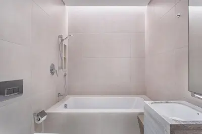 a white bathroom with a tub and a sink at Family Sky Retreat at Address Beach on 56th Floor in Dubai