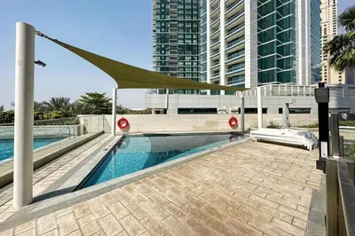 a swimming pool in a city with tall buildings at Family Sky Retreat at Address Beach on 56th Floor in Dubai